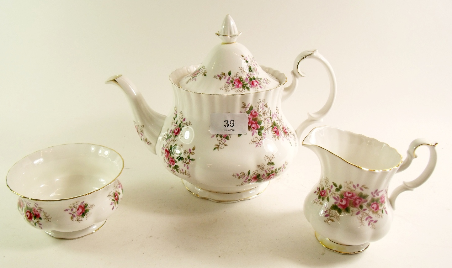A Royal Albert Lavender Rose tea service comprising teapot, milk, sugar, cake plate, six cups