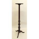 A mahogany torchiere stand, 131cm high