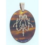 A 9ct gold tortoiseshell and gold pique pendant, 4.7cm