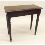 An Edwardian dark wood side table on turned supports