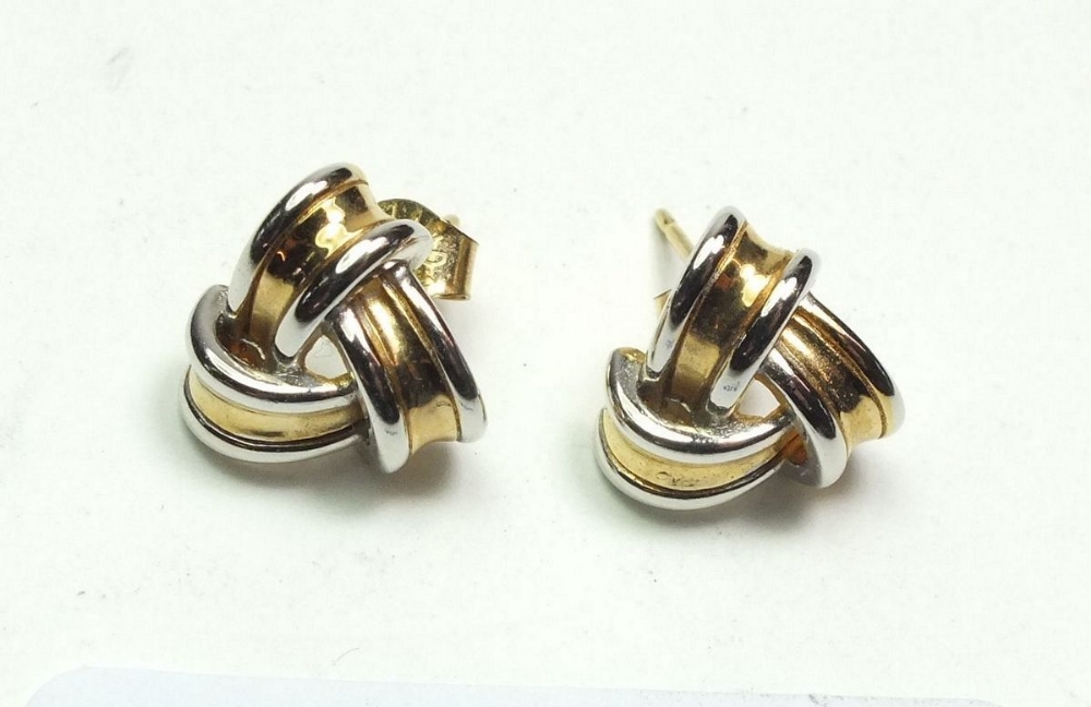 A pair of white and yellow gold earrings