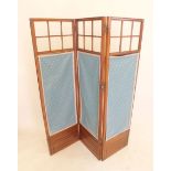 An early 20th century three fold mahogany screen with glazed upper section