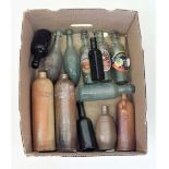 A collection of glass and stoneware bottles including stoneware flasks marked Rotterdam