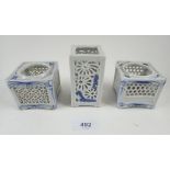 Three Chinese pierced blue and white porcelain candle holders