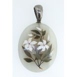 An Italian marble pietra dura pendant decorated lilies, with locket back
