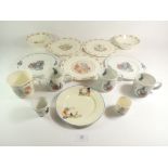 A collection of nursery china comprising two Wedgwood Peter Rabbit plates and four mugs, three