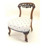 A Victorian mahogany chair with low floral carved back