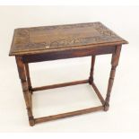 An oak side table with carved top on turned supports, 66cm wide
