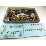 A box of costume beads and various earrings