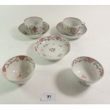 A pair of 18th century English Newhall style porcelain cups and saucers painted flowers (one cup