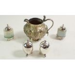 A Indian white metal jug with embossed decoration, a pair of silver small egg form cruets Birmingham