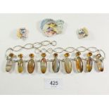 A 1960's agate and citrine coloured necklace with two dolphin ceramic brooches by Maralyn Reed-Wood.