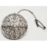 An Edwardian platinum diamond set Belle Epoque brooch of openwork design, 3cm diameter, 9g