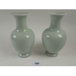 A pair of Chinese celadon baluster vases 16cm, on stands