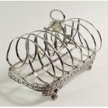 A Georgian silver toast rack with shell and leaf paw feet, 292g, 17.5 cm long, London 1834 by