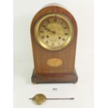 An Edwardian arch top mantel clock with paterae marquetry