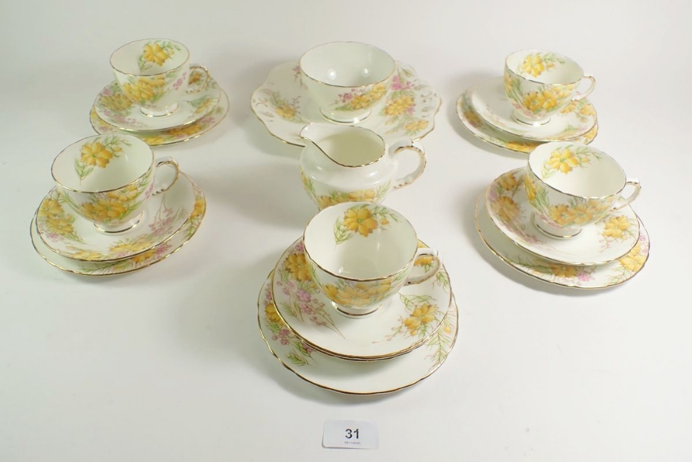 A Sutherland tea service comprising: five cups and saucers, five tea plates , cake plate , milk