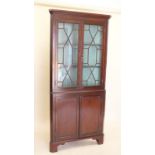 A 19th century mahogany corner cupboard with glazed upper display section