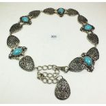 A Middle Eastern white metal and turquoise panelled belt