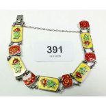 A silver and enamel link bracelet with rose and flower head links, 21 gm