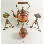 A Victorian copper kettle with acorn finial, a brass trivett, two brass fire dogs and an Arts &