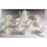 A Shelley white group of tea and coffee ware consisting of coffee pot, three tea plates, three tea