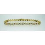 A fine 18 ct gold collet set diamond line bracelet, (approx 10 cts diamonds)