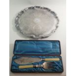 A silver plated pie crust edge tray and a pair of Victorian silver plate fish servers, cased