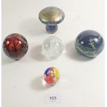 A selection of five paperweight to include an iridescent mushroom weight, a Mdina, a Caithness, a