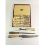 A set of six horn handled steak knives and a horn handled carving set