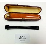 An amber cigarette holder cased by Fribourg & Treyer and a cigarette holder