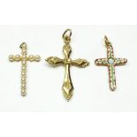 A yellow metal crucifix, a micro mosaic crucifix and a pearl set one