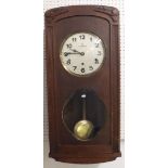 A French 1950's striking oak wall clock with pendulum and key