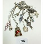 A selection of silver and white metal chains with pendants.