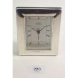 A silver framed clock, 12cm tall
