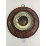 A carved mahogany circular barometer