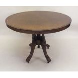 A Victorian mahogany tilt top circular occasional table on turned column and triple curved supports,