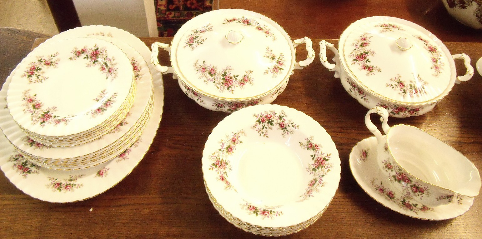 A Royal Albert Lavender Rose dinner service comprising meat plate, six dinner plates, gravy boat,