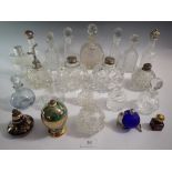 A large collection of cut glass perfume or scent bottles