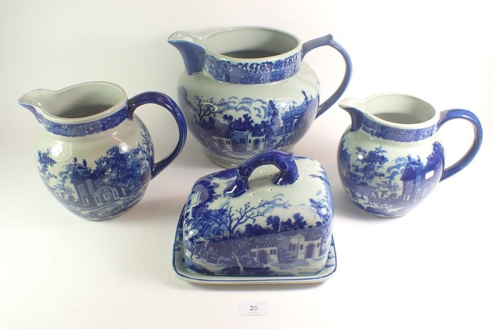 Three large blue and white pottery jugs plus a cheese/butter dish