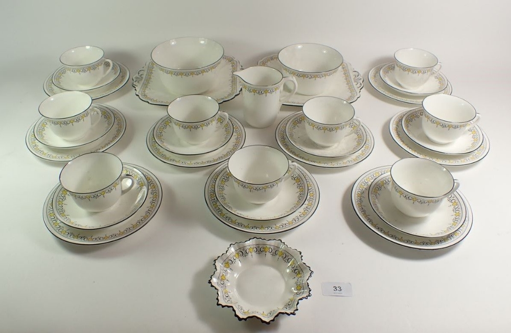 A 1920's Shelley porcelain tea set in the Bell pattern (no. 11233), comprising 9 trios, 2 cake