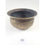 A bronze Chinese bowl with cast decoration, 17cm diameter