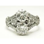 A fine Art Deco 18 carat white gold ring set two diamonds on triple diamond set shoulders, 4.7g,