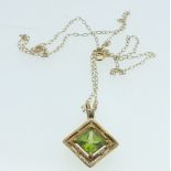 A 9 carat gold square pendant set peridot and chip diamonds