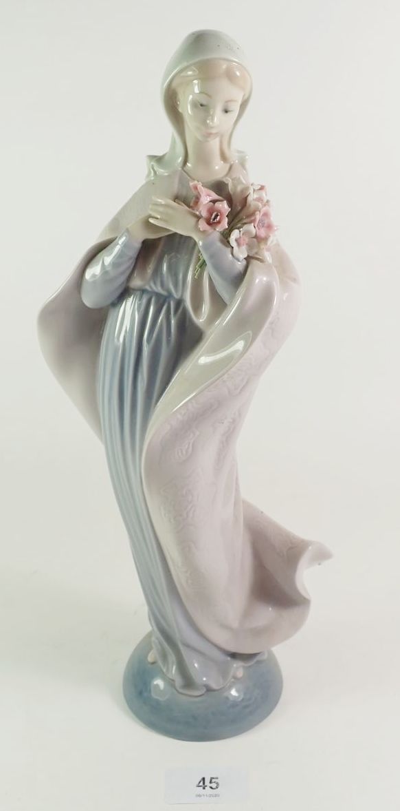 A Lladro figure with flowers