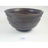 An early wooden Chinese bowl, repaired extensivley, 21 cm diameter