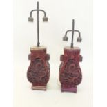 A pair of Chinese red lacquer table lamps, 34cm tall