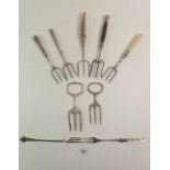 A collection of silver plated bread forks and pickle forks etc.