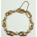 A 15 ct fancy link bracelet set opals and rubies, 16 gm