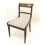 A 20th century Regency style chair with brass inlay